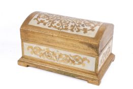A carved gilt wood dome top casket.
