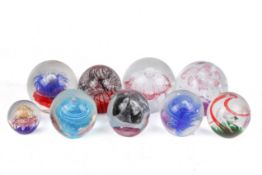 A collection of contemporary large glass paperweights.