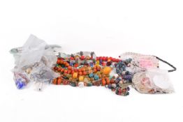A group of Indian and Tibetan beaded jewellery in two trays. Including turquoise, glass, coral, etc.