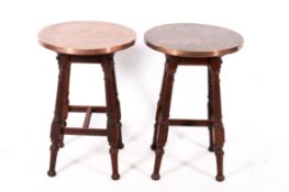 A pair of copper topped tables.