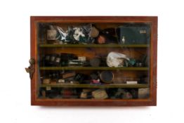 A wall mounted wooden framed vintage display cabinet and contents.