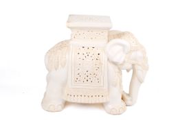 A large ceramic elephant plant stand.