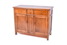A substantial stained oak sideboard.