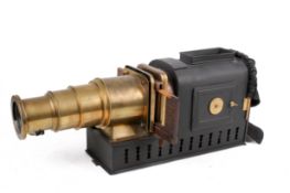 A Victorian magic lantern slide. Having a japanned tinplate body and brass lens, H23.