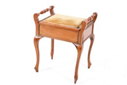 A 20th century mahogany box seat piano stool. Having hinged seat and turned side rails.