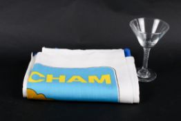 A vintage Babycham tea towel an unusual drinking glass.