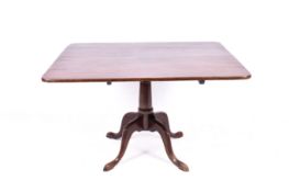 A large mahogany tilt-top table.