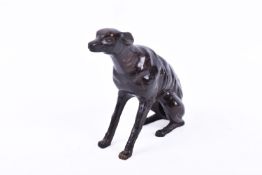 A 20th century bronze sculpture of a greyhound. In a seated position, unsigned, height 16.