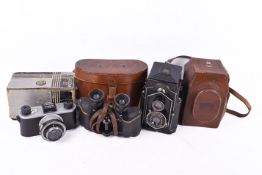 Two vintage film cameras and a pair of binoculars.