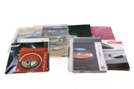 A collection of car sales brochures.