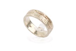 A white metal band ring. With textured surface and sides, marked 9ct, size T, weight 7.1g.