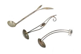 Three silver and white metal Lucy Woodley spoons.