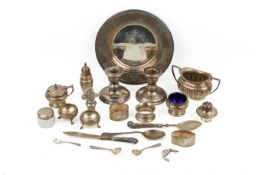 A collection of silver and white metal table items.