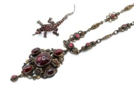 A marked sterling silver garnet necklet and a brooch.