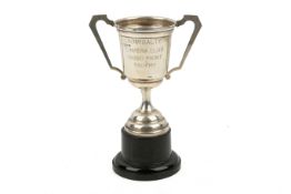 A weighted silver trophy cup.