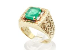 An emerald and diamond dress ring. The emerald of 2.
