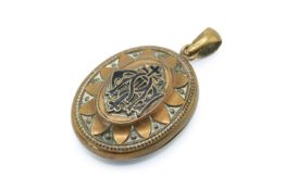 A Victorian gold plated pendant locket in an ebonized box.