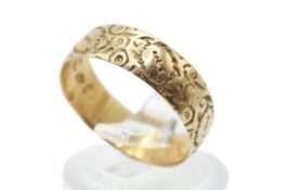 An engraved 18ct gold band ring.