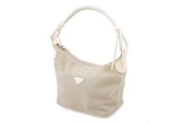 A Prada re-edition cream nylon mini hobo handbag.