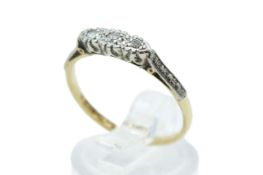 A yellow metal and three stone diamond ring.