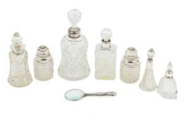A group of silver and white metal mounted dressing table bottles and a magnifying glass.