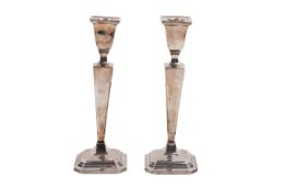 A pair of weighted silver candlesticks.