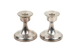 A pair of early 20th century weighted silver candlesticks.