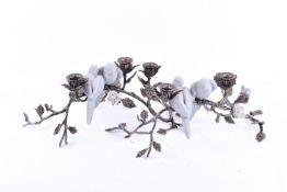 A pair of white metal candlesticks.