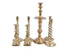 A group of seven brass candlesticks. Consisting of three pairs and one large.