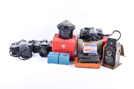 A collection of assorted film cameras and photographic equipment.