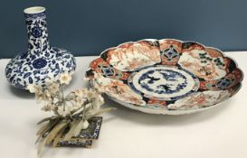 A Chinese blue and white gourd-shaped vase with all-over foliate and floral decoration,