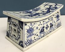 A Chinese blue and white pillow or head rest, the top decorated with phoenix and five toed dragon,