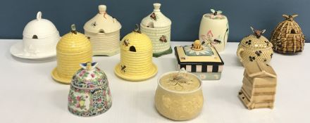 A collection of twelve assorted honey pots including a famille rose style pot,