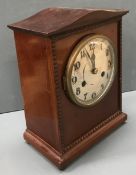 An early 20th Century mahogany cased mantle clock, the brushed dial set with Arabic numerals, 28.