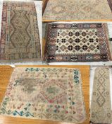 Five Kelim rugs comprising one with multi-coloured lozenge medallions on a cream ground,