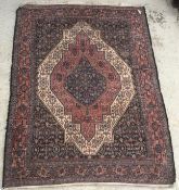 A Persian rug, the central panel set wit
