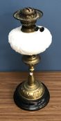 A Victorian brass oil lamp with embossed