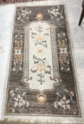 A Nepalese rug, the central panel set wi