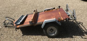 A motorcycle trailer, together with ramp