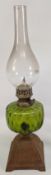 Lawn Tennis themed Oil Lamp, cast iron base with early lawn tennis scene, green glass reservoir
