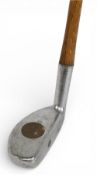 Bunny putter by the Rangefinder Golf Co with the central round brass plug through the head showing