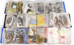 A large collection of fly tying materials in folders and bundles: wool, bucktails, fox, squirrel,
