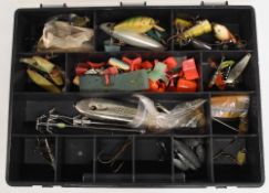 Double sided tackle case holding a quantity of plastic and wood plugs, assorted hooks and terminal