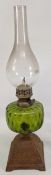 Lawn Tennis themed Oil Lamp, cast iron base with early lawn tennis scene, green glass reservoir