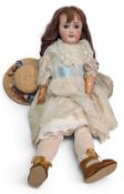 Early 20th century French Limoges Bisque Head Girl Doll with replacement wig, striated blue glass