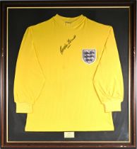 Gordon Banks Signed England Football Shirt a yellow goalkeeper shirt with autograph in ink to front,