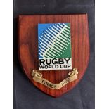 1999 RWC Classic Shield Shaped Rugby Wall Plaque: Brown with colourful IRB RWC logo and title/date