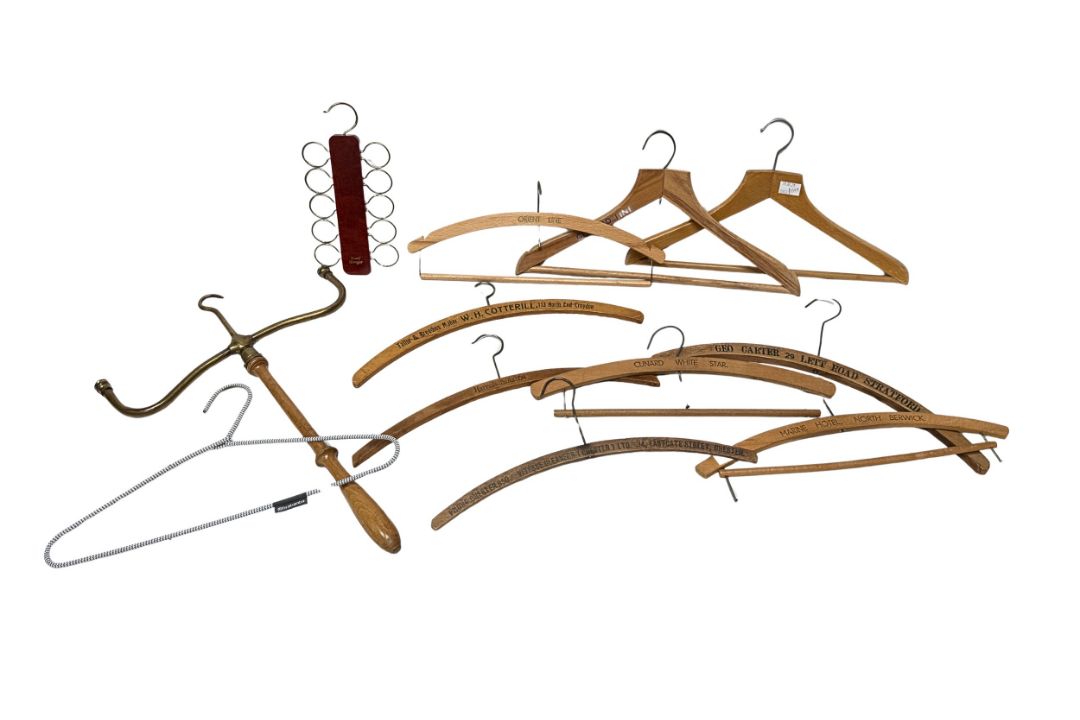 A collection of assorted vintage wooden coat hangers including an interesting barristers cloak