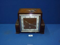 An Oak veneer Art Deco Westminster chime mantle clock having a three-train spring-driven movement,