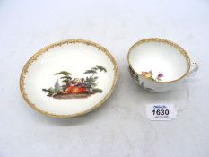 An 18th century Meissen tea bowl and saucer, circa 1750, painted figures in garden vignettes,